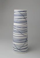 Small cylindrical porcelain vessel with blue abstract lines by Ali Tomlin