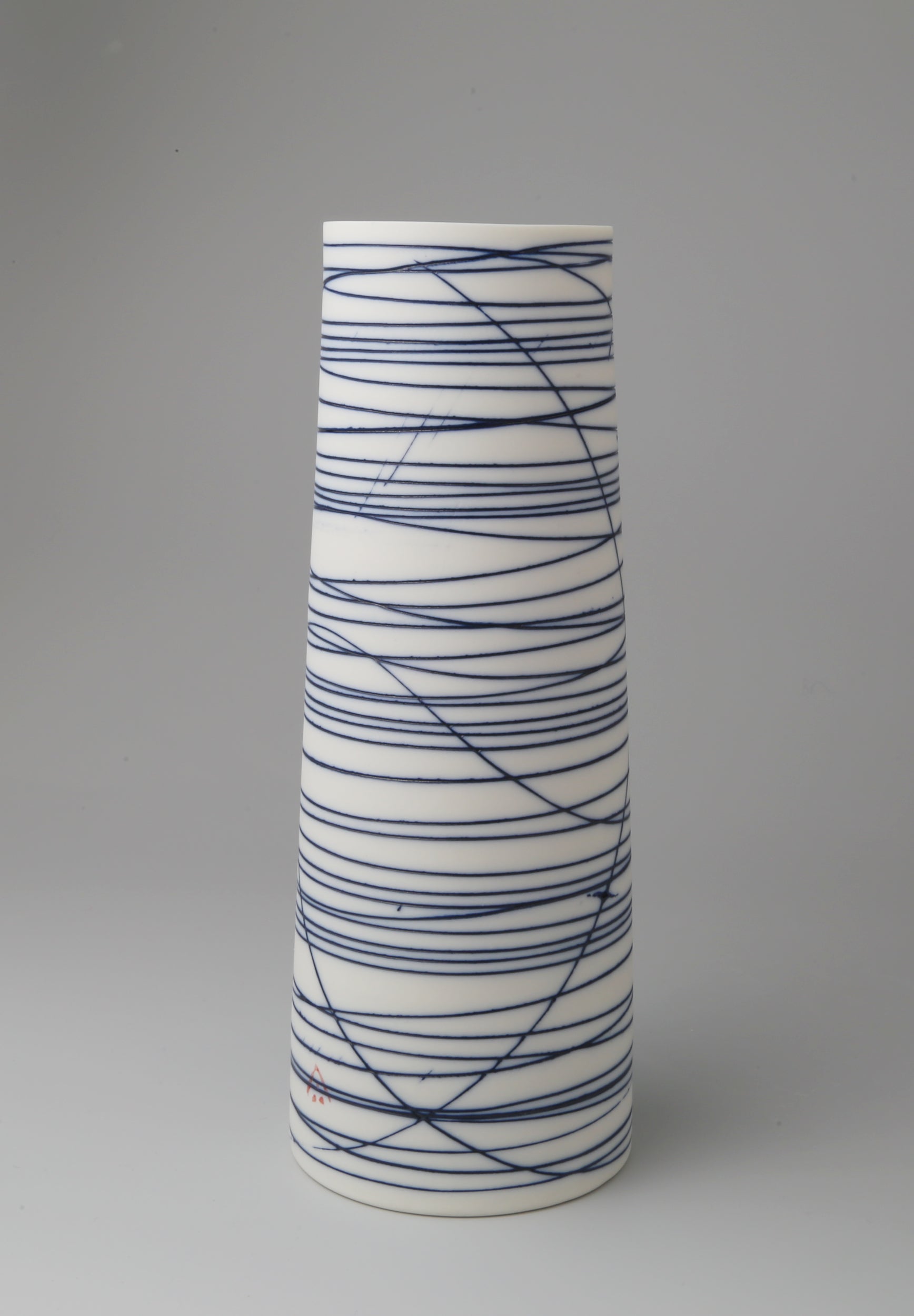 Small cylindrical porcelain vessel with blue abstract lines by Ali Tomlin