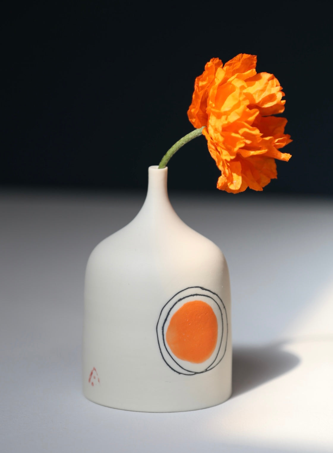 Small porcelain vase decorated with an orange painted dot and two circles by Ali Tomlin