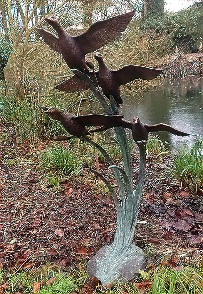Garden sculpture of ducks in flight by John Cox