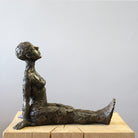 Bronze sculpture sitting in contemplation by Carol Peace.