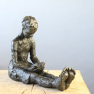 Bronze sculpture of girl reading a book by Carol Peace