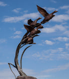 Garden sculpture of ducks in flight by John Cox