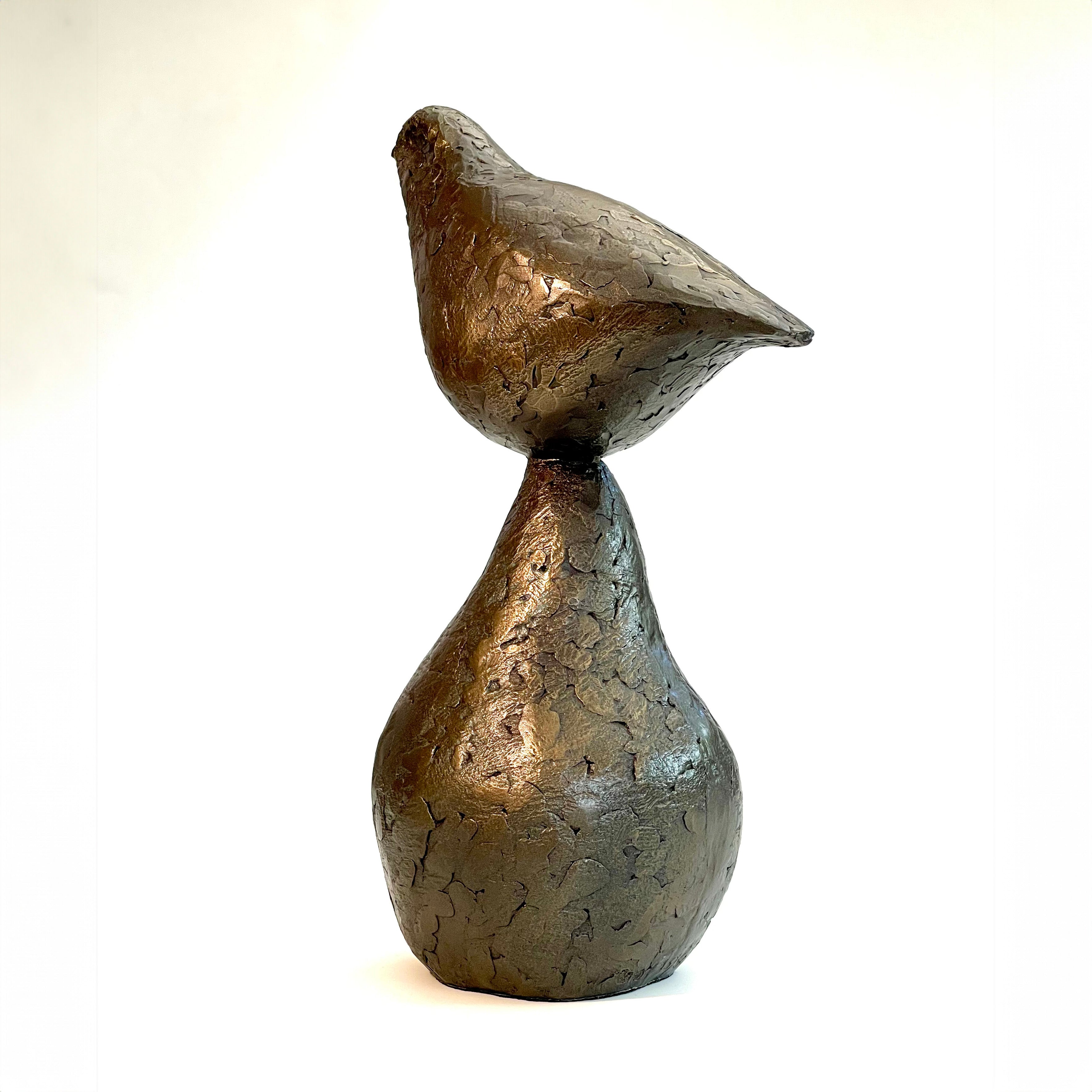 Small bronze sculpture of bird sitting on pear by Caro Burberry