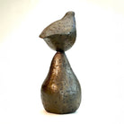 Small bronze sculpture of bird sitting on pear by Caro Burberry