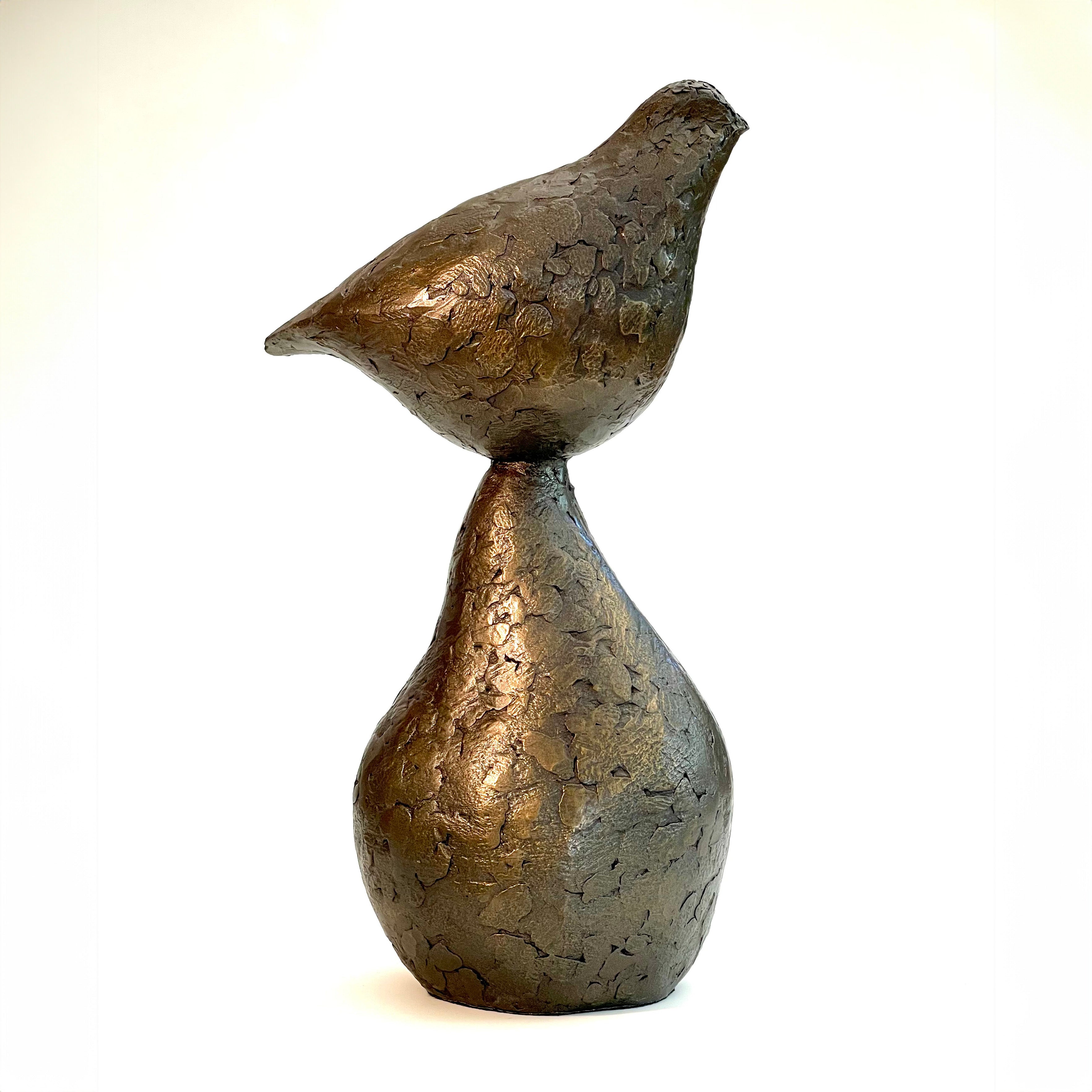 Small bronze sculpture of bird sitting on pear by Caro Burberry