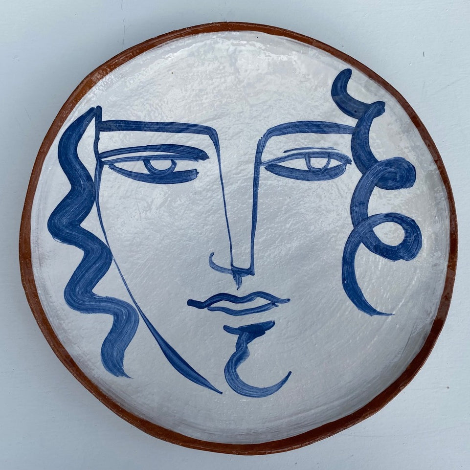 Earthenware decorative plate of face by Kate Reynolds.