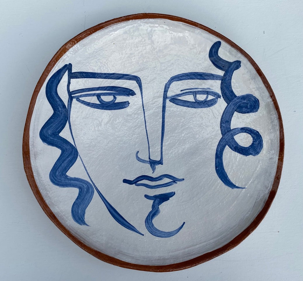 Earthenware decorative plate of face by Kate Reynolds.