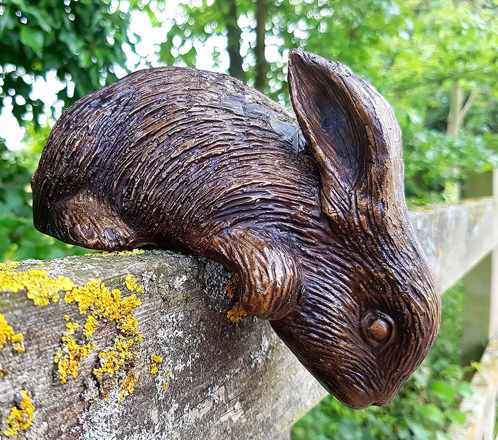 Bronze garden sculpture of small rabbit by John Cox