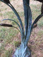 Close up of reeds on garden sculpture of ducks in flight by John Cox