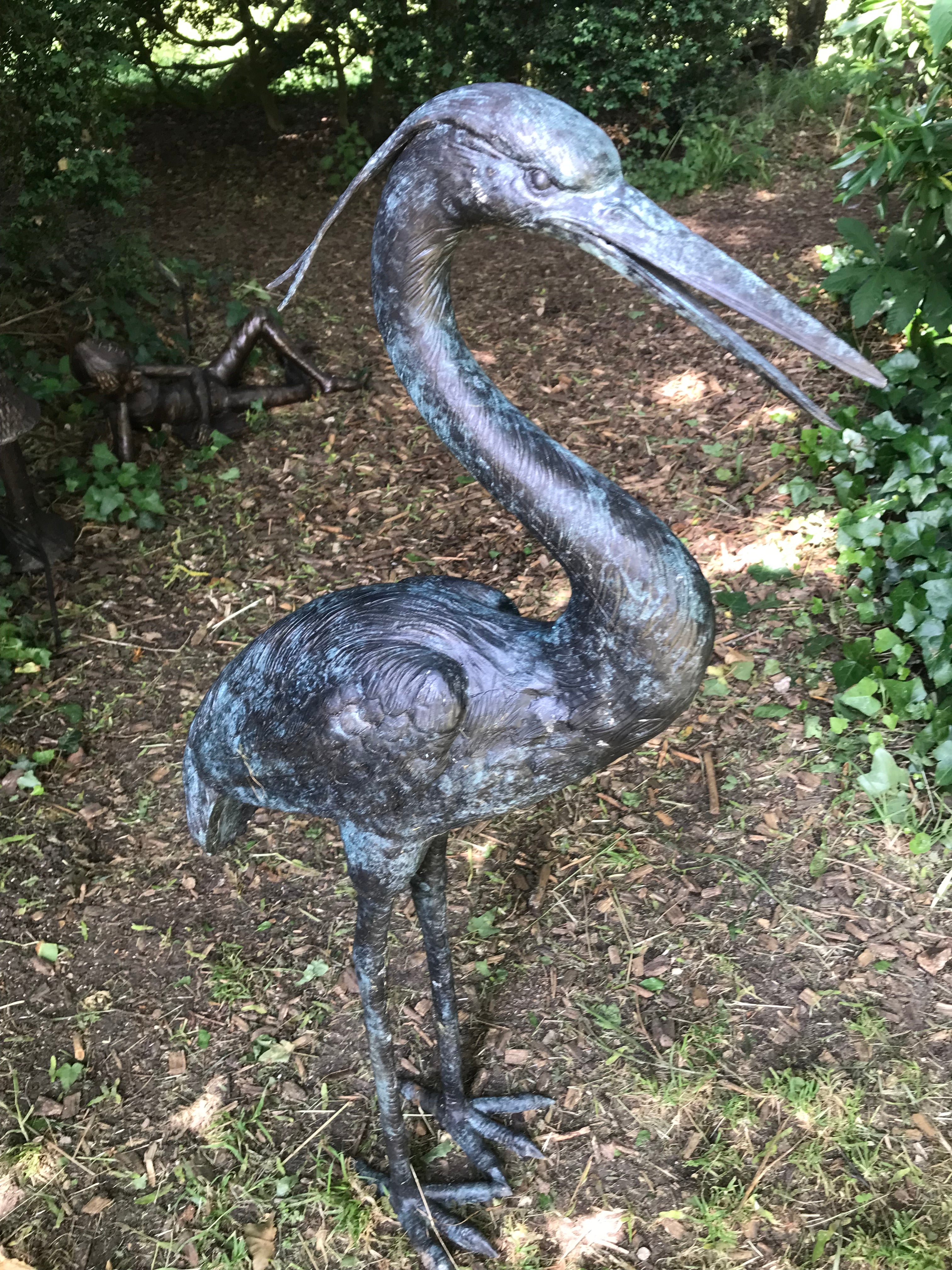 Bronze garden sculpture of heron by John Cox