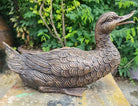 Garden sculpture of bronze cast duck by John Cox.