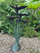 Garden sculpture of ducks in flight by John Cox