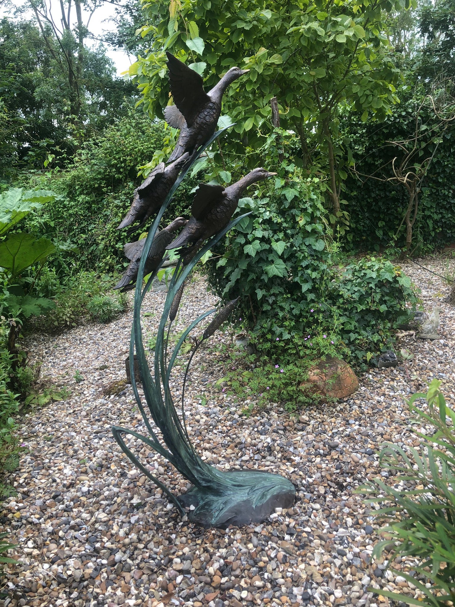 Garden sculpture of ducks in flight by John Cox