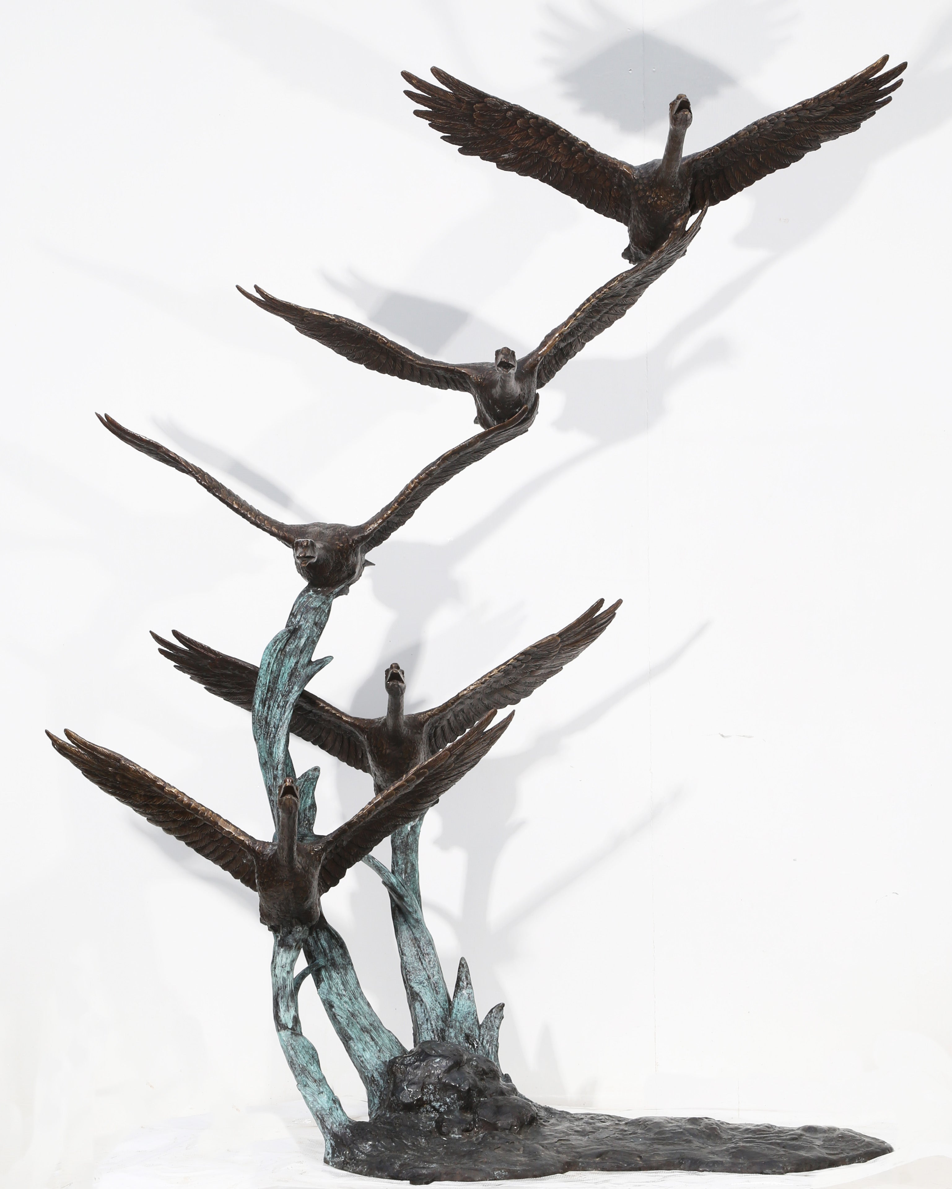 Garden sculpture of flying geese in bronze by John Cox