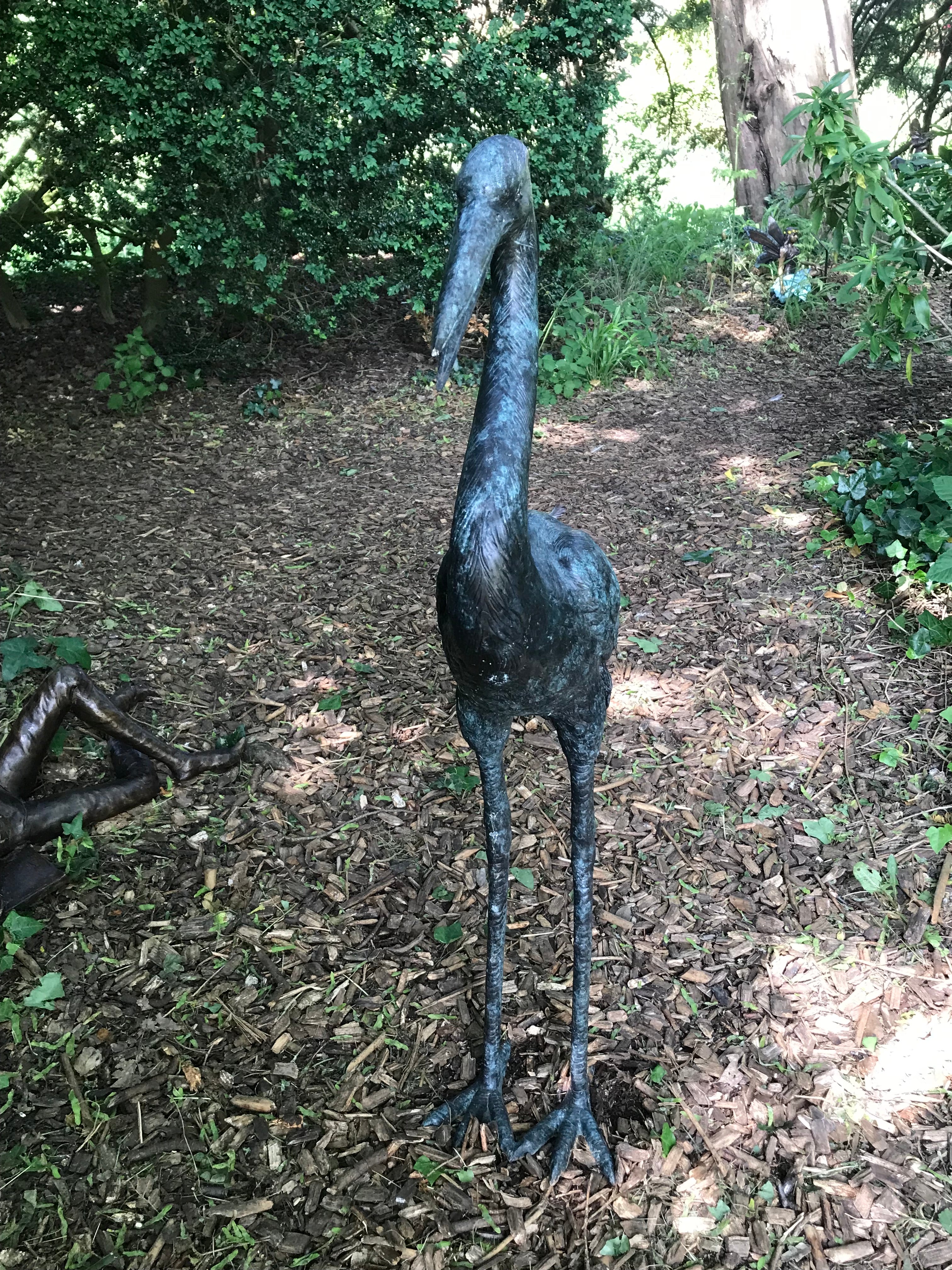 Bronze garden sculpture of heron by John Cox